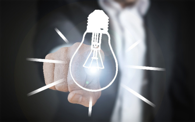 A picture of a person pointing at a drawing of a lightbulb. Veritas Global Protection Highlights The Importance Of Innovation In Business