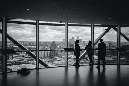 A picture of a group of people looking out a window of their business after Dorado Management Services helped them