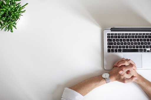 A picture of a person sitting by their laptop debating what business structure their business should be