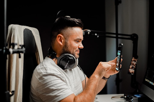 A picture of a podcaster creating top-quality content for their social media as Darren and Mike suggest.